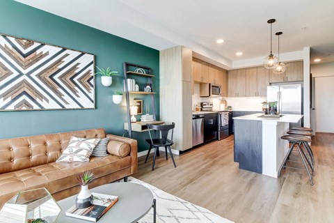 a living room and kitchen with a couch and a table